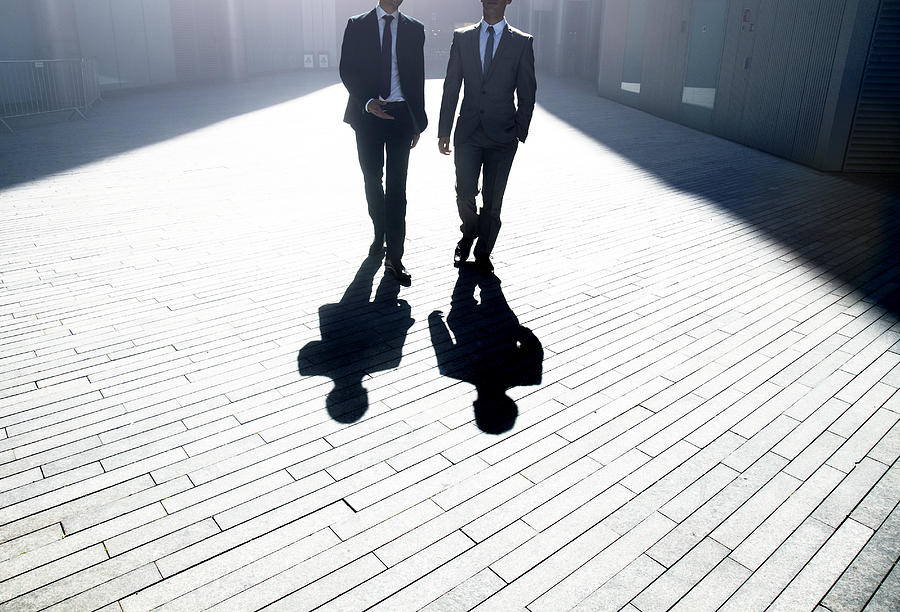 Two businessmen walking through the city. #1 Photograph by Ezra Bailey