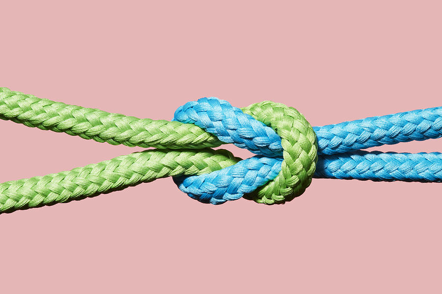 Two coloured ropes knotted together #1 Photograph by Richard Drury
