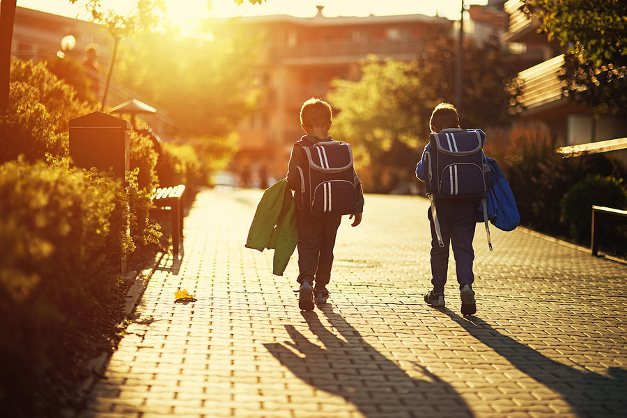 Two little boys returning from school Photograph by Imgorthand