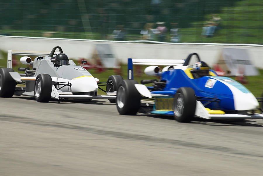 Two racecars racing on a motor racing track #1 Photograph by Glowimages