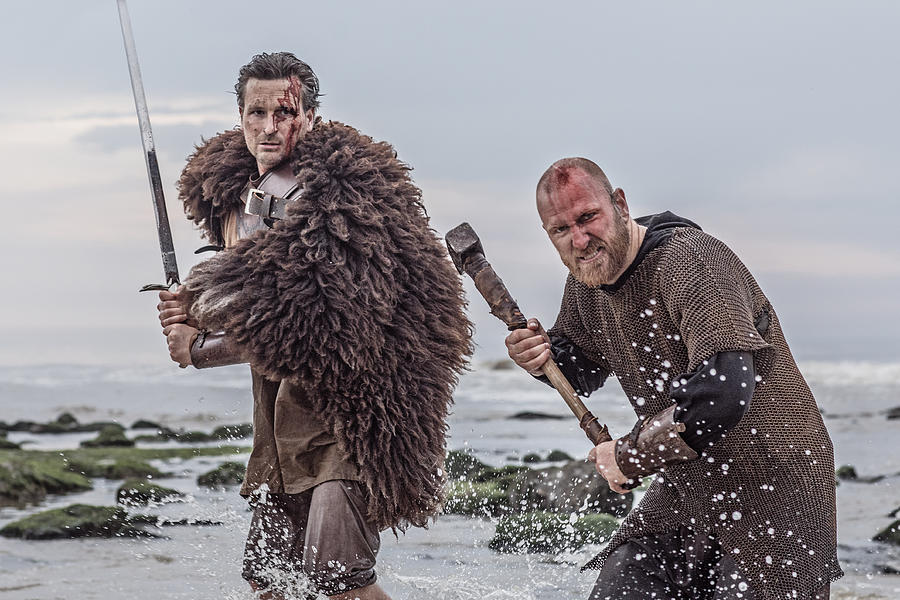 Two sword wielding bloody medieval warriors together on a cold seashore #1 Photograph by Lorado