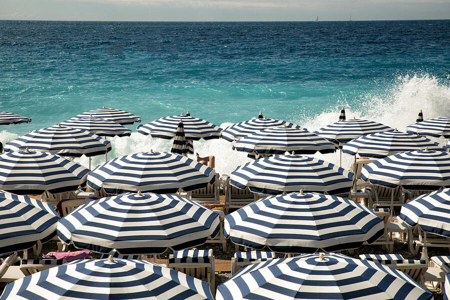 Umbrellas on the beach in Nice #1 Photograph by Jean-Marc PAYET