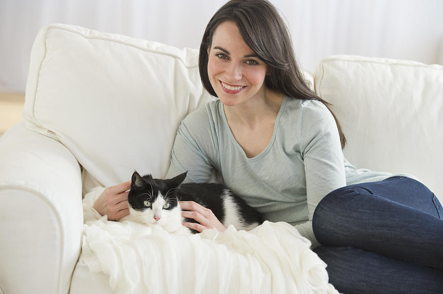 USA, New Jersey, Jersey City, portrait of woman with cat on sofa #1 Photograph by Tetra Images