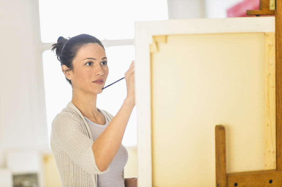 USA, New Jersey, Jersey City, Woman painting at easel #1 Photograph by Tetra Images