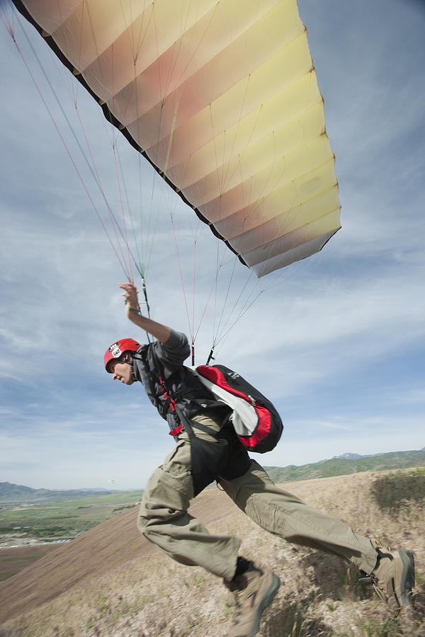 USA, Utah, Lehi, young paraglider starting from hill #1 Photograph by RubberBall Productions