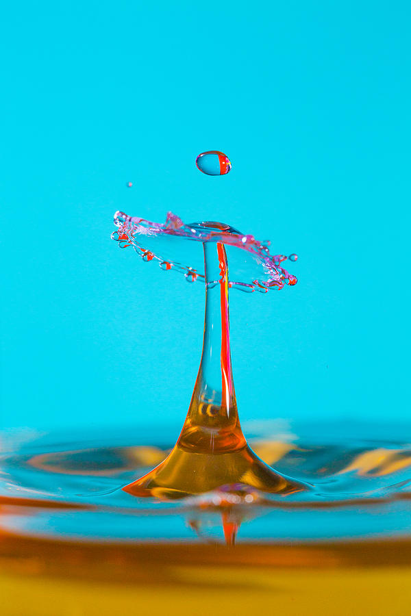 Water Drip On a blue backdrop #1 Photograph by Robbie Goodall