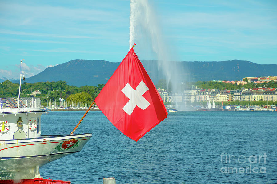 Water jet fountain and Swiss flag #1 Photograph by Benny Marty
