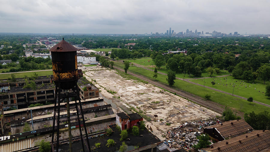 Water Tower At Abandoned Packard Automotive Plant With Detroit Skyline Photograph