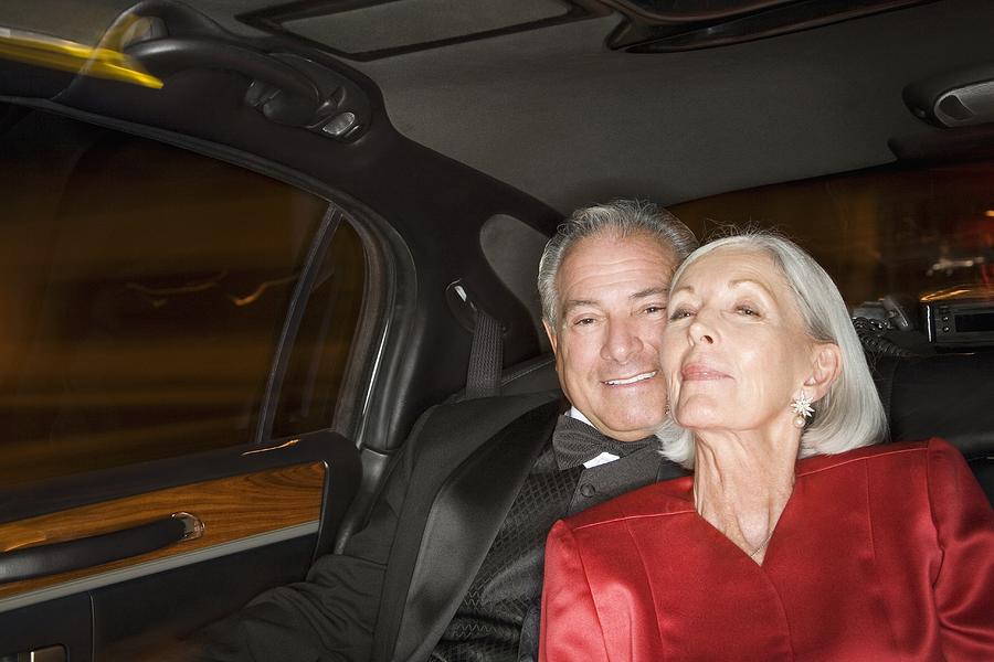 Well dressed senior couple in limousine #1 Photograph by PictureNet Corporation