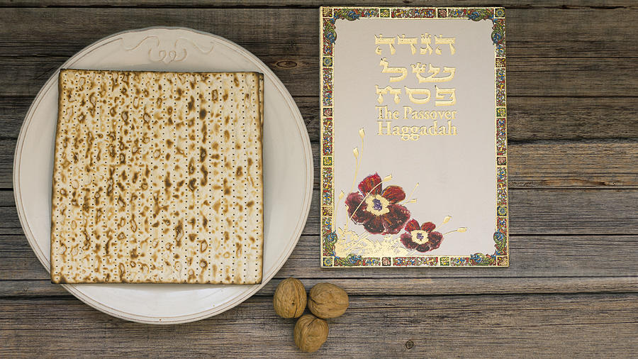 White plate  with matzah or matza and Passover Haggadah on a vintage wood background presented as a Passover seder feast or meal with copy space #1 Photograph by Vlad Fishman