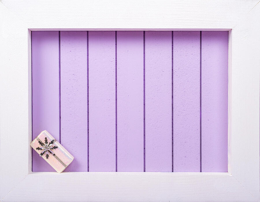 White wooden frame and  christmas decoration over a purple background #1 Photograph by DiyanaDimitrova