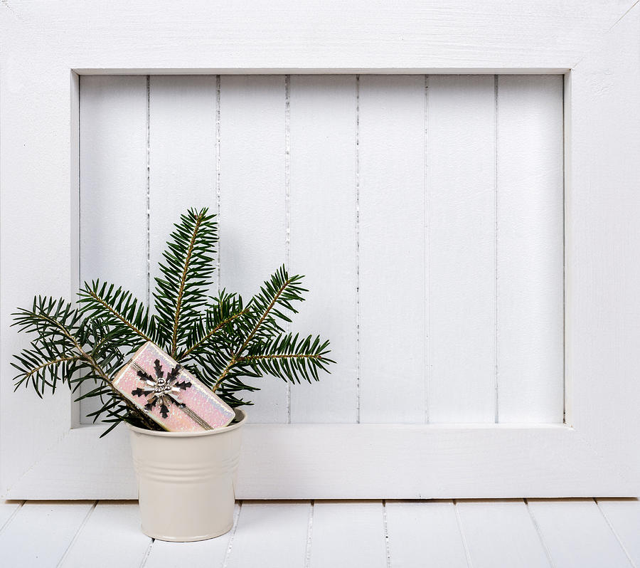 White wooden frame and  christmas decoration over white background #1 Photograph by DiyanaDimitrova