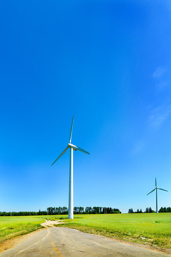 Wind generator in the meadows, on a background of blue #1 Photograph by Nordroden