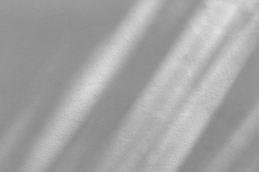 Window shadow drop on white color old grunge wall concrete texture as background. Photograph by Pakin Songmor