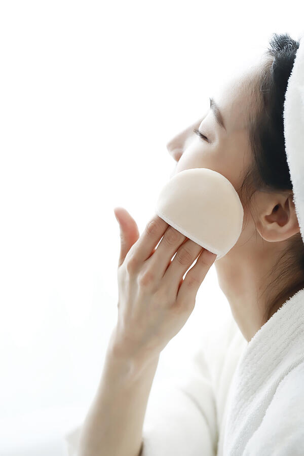 Woman applying face powder #1 Photograph by Runstudio