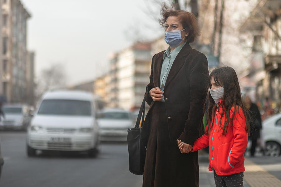 woman are going to work.she wears N95 mask.prevent PM2.5 dust and smog, mother and child wearing a mask to protect their child from air pollution and infectious diseases #1 Photograph by Phynart Studio