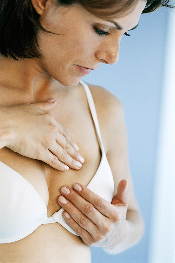 Woman doing breast self exam #1 Photograph by BananaStock