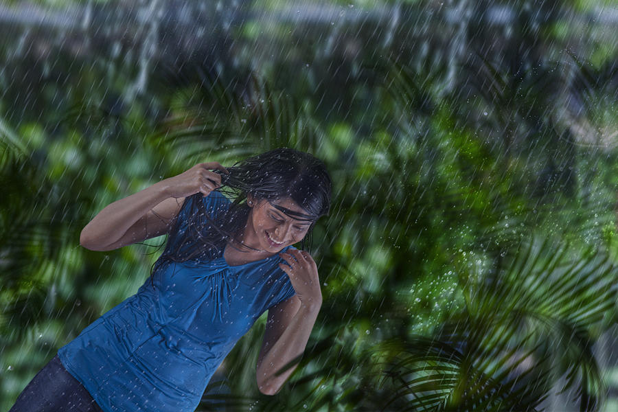 Woman enjoying in the rain #1 Photograph by Abhinandita Mathur 