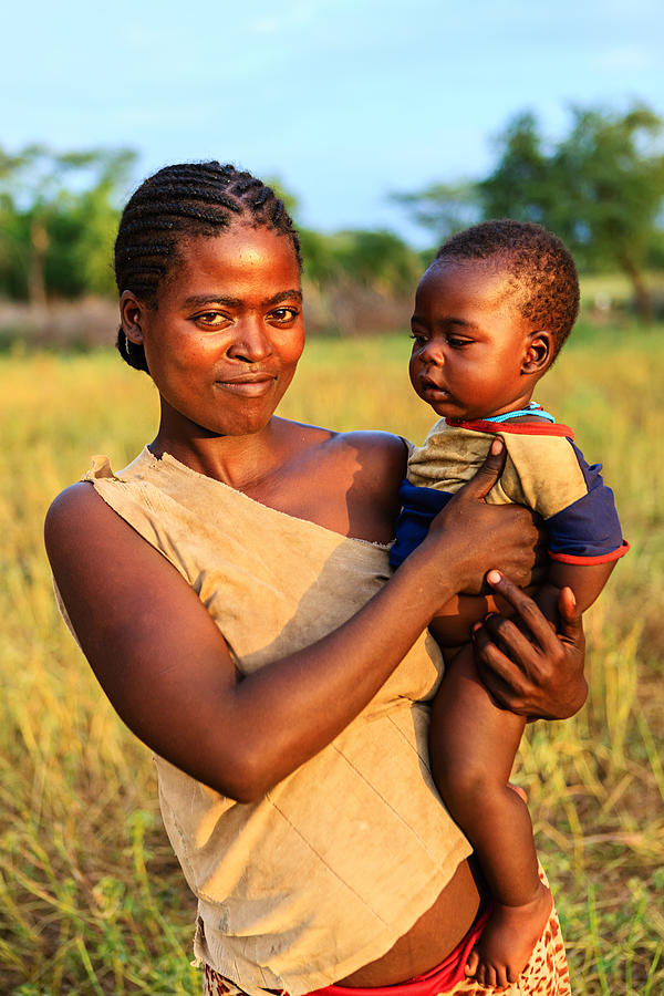 Woman from Samai tribe holding her baby, Ethiopia, Africa #1 Photograph by Hadynyah