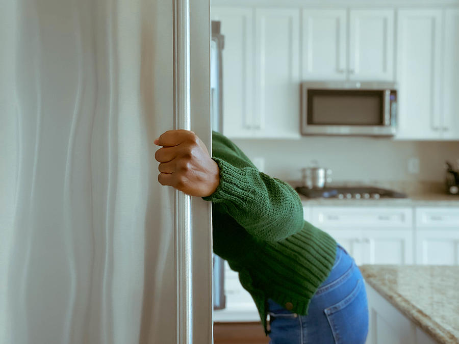 Woman Looks into Refrigerator for Healthy Snack Photograph by Grace Cary
