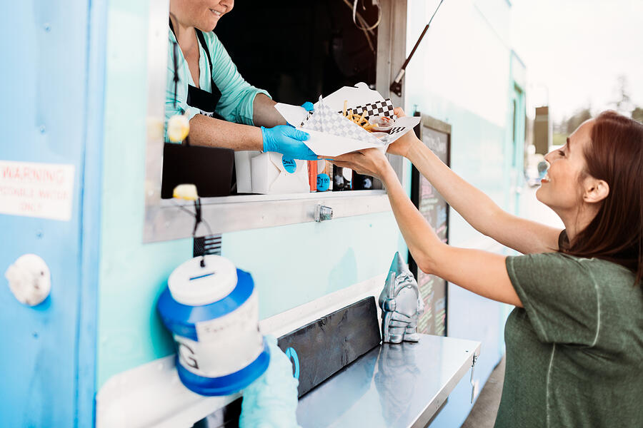 Woman Receiving Order at Food Truck #1 Photograph by RyanJLane