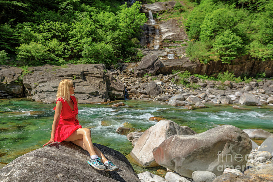 woman relaxing by Verzasca riverside #1 Photograph by Benny Marty