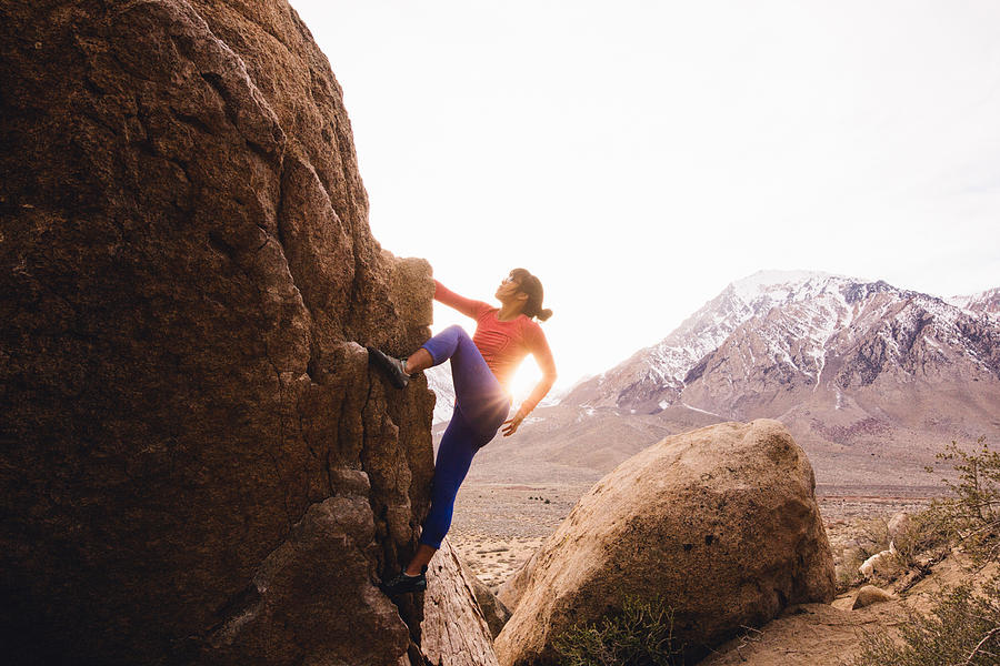 Woman rock climbing, Buttermilk Boulders, Bishop, California, USA #1 Photograph by Peter Amend