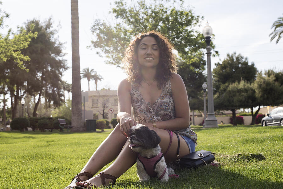 Woman sitting in park with dog #1 Photograph by Scott Zdon