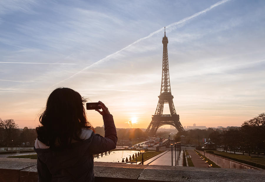 Woman taking a photo of the Eiffel tower, Paris, France #1 Photograph by Matteo Colombo
