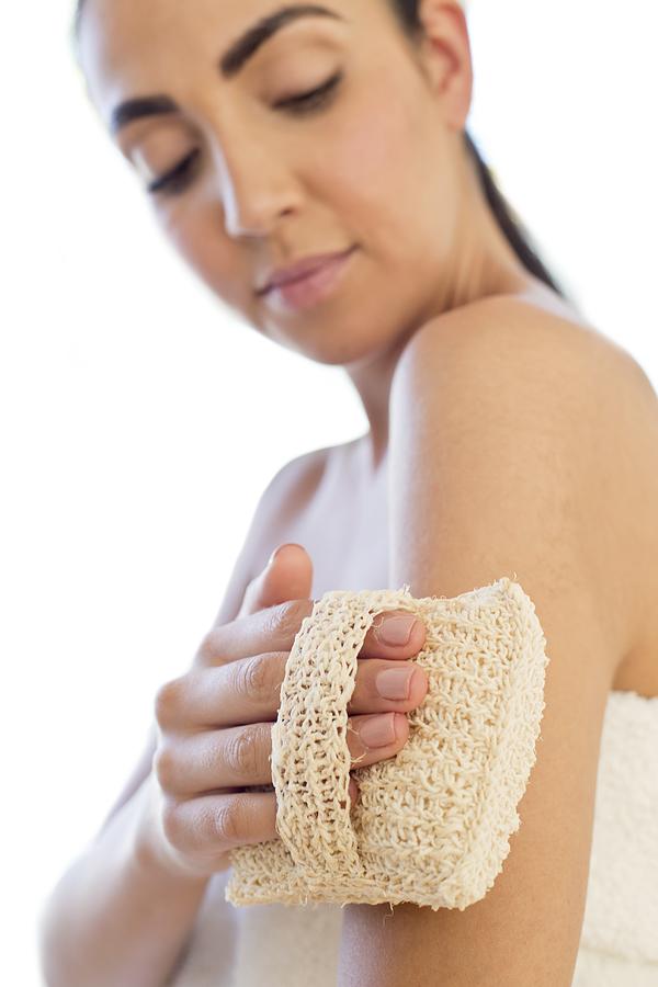 Woman using loofah mitt on arm #1 Photograph by Ian Hooton/science Photo Library