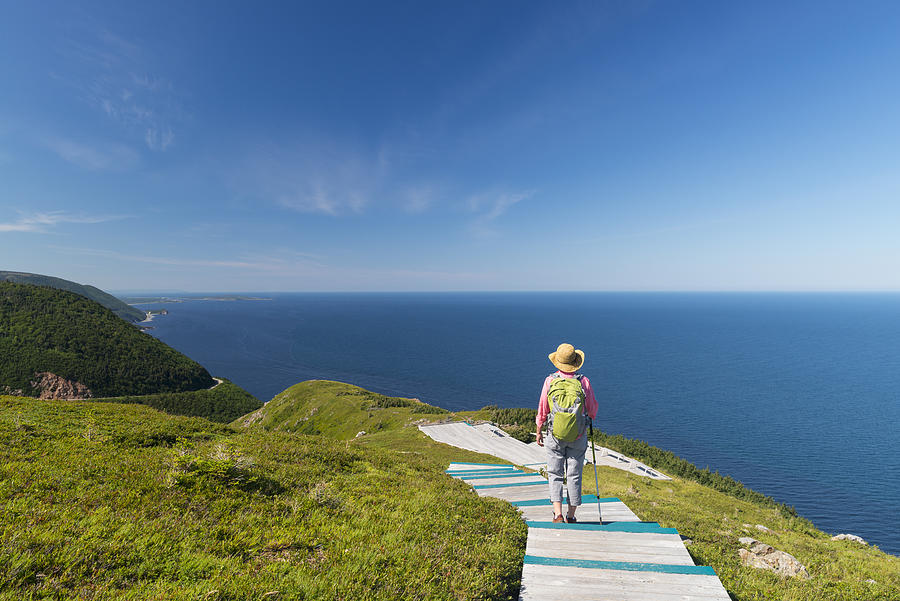 Woman walking, hiking, Skyline, Cabot trail, Cape Breton, Nova Scotia #1 Photograph by Pchoui