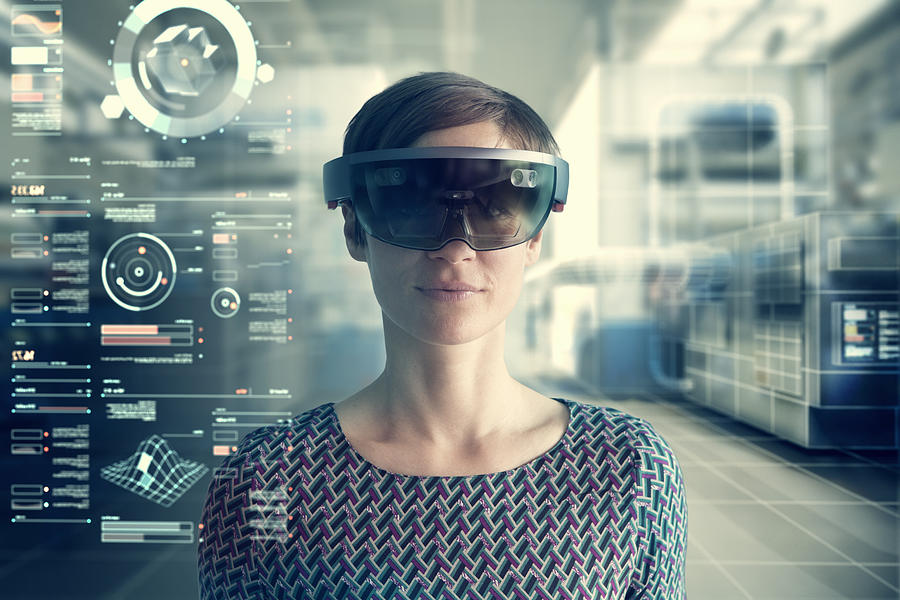 Woman wearing mixed reality smartglasses at transparent screen #1 Photograph by Westend61