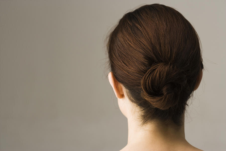Woman with hair arranged in chignon, rear view #1 Photograph by PhotoAlto/Frederic Cirou