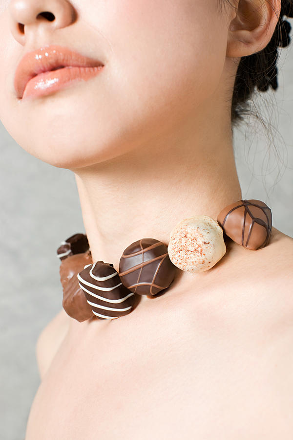 Woman with necklace of chocolates #1 Photograph by Image Source