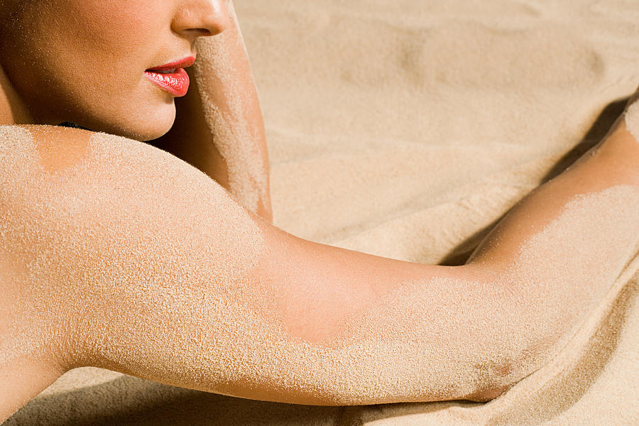 Woman with sand on her skin #1 Photograph by Image Source