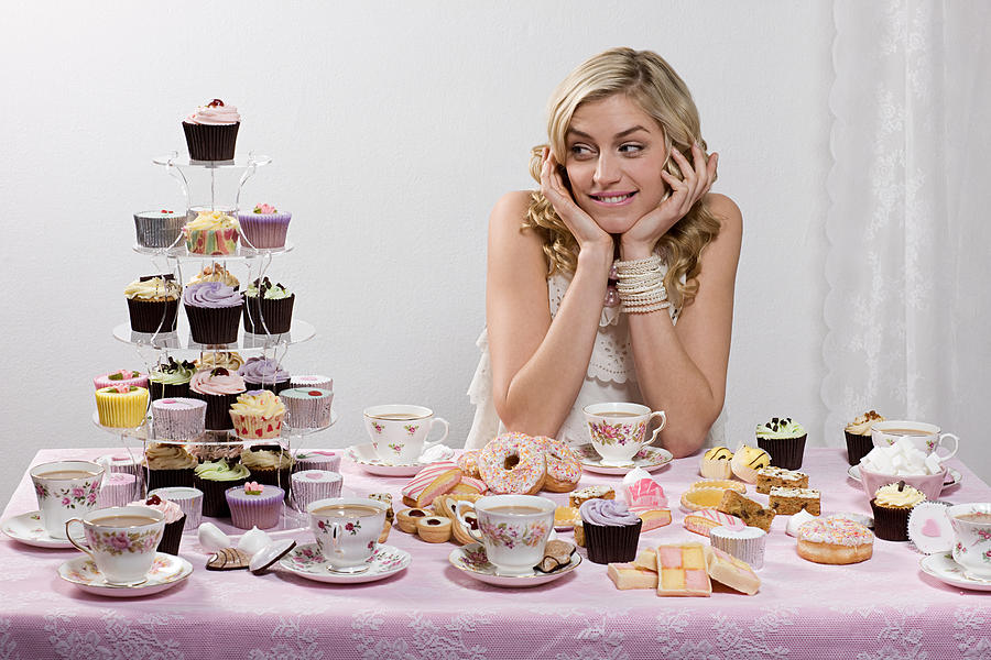 Woman with table of tea and cakes #1 Photograph by Image Source
