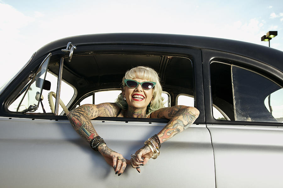 Woman with tattoos leaning out window of 1951 Chevy #1 Photograph by Tom M Johnson