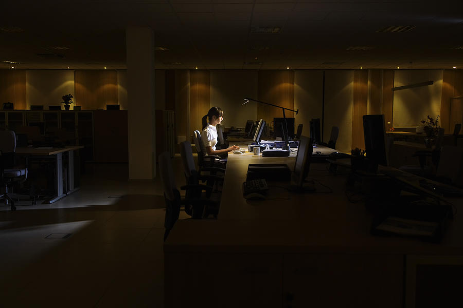 Woman Working in Dark Office #1 Photograph by Moodboard