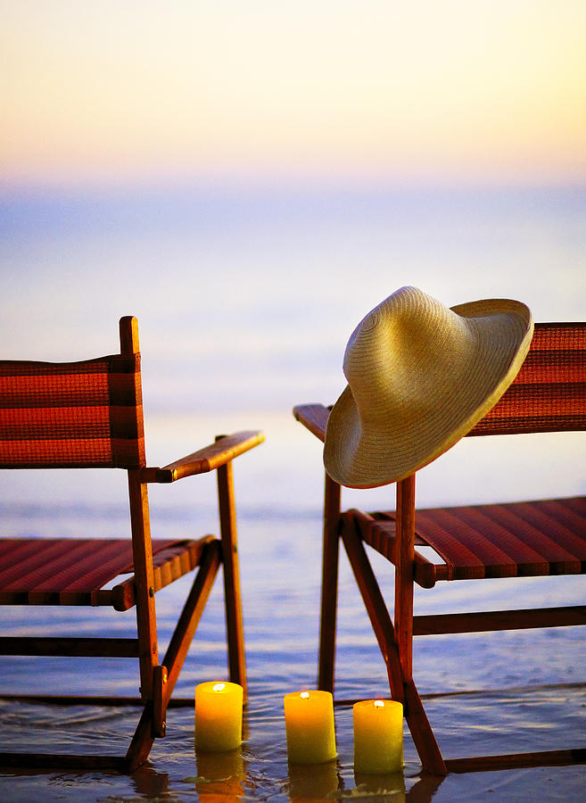 Wooden beach chairs on beach at sunset or sunrise, #1 Photograph by Stevecoleimages