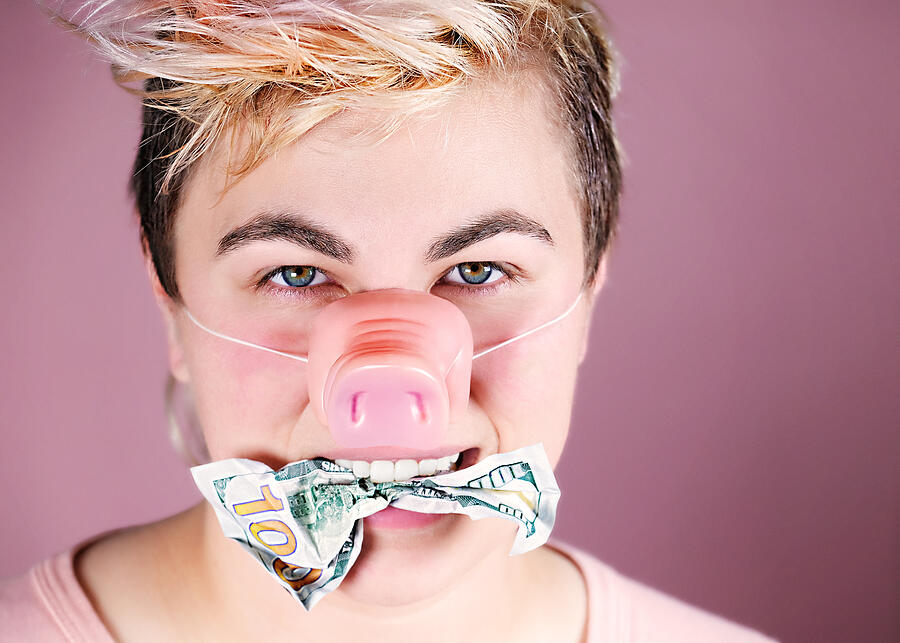 Young Adult Wearing Pig Nose with Money in Mouth #1 Photograph by Juj Winn