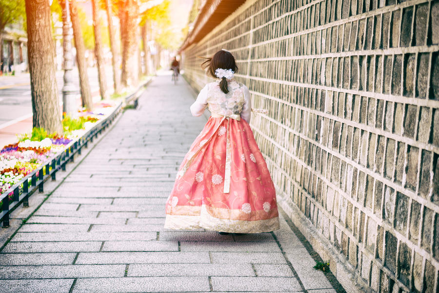 Young asian woman traveler in korean national dress or Hanbok walking traveling into the Gyeongbokgung Palace at Seoul city, South Korea. #1 Photograph by Mongkol Chuewong