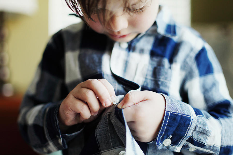 Young Child Buttoning Shirt #1 Photograph by Jurgita.photography