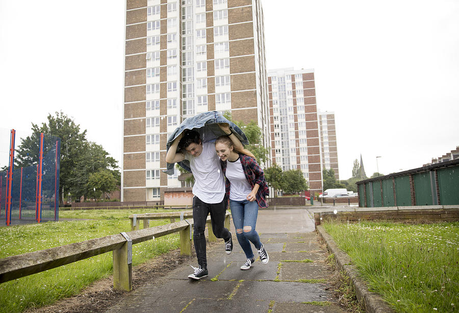 Young Couple Run In The Rain #1 Photograph by SolStock