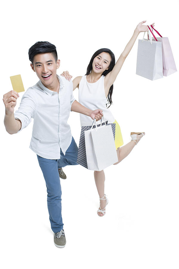 Young couple shopping with credit card #1 Photograph by BJI / Blue Jean Images