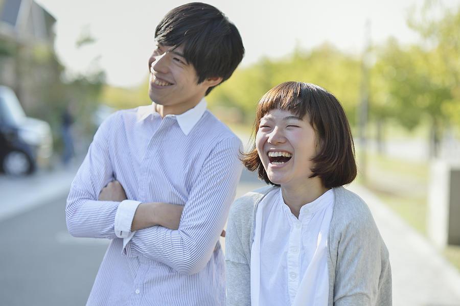 Young couple standing in the residential area #1 Photograph by Yagi Studio