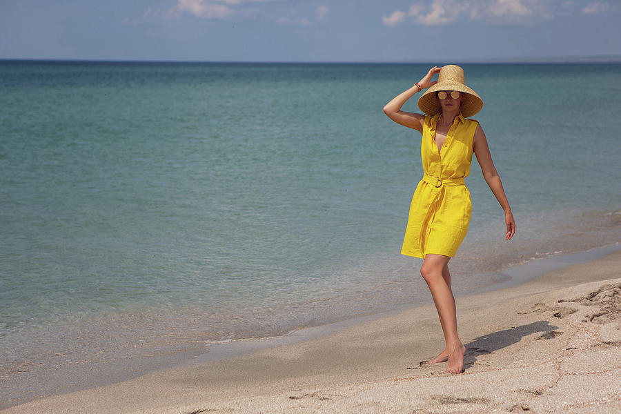Young Fashionable Woman In A Yellow Hat Dress And Sun Glasses Is Posing ...
