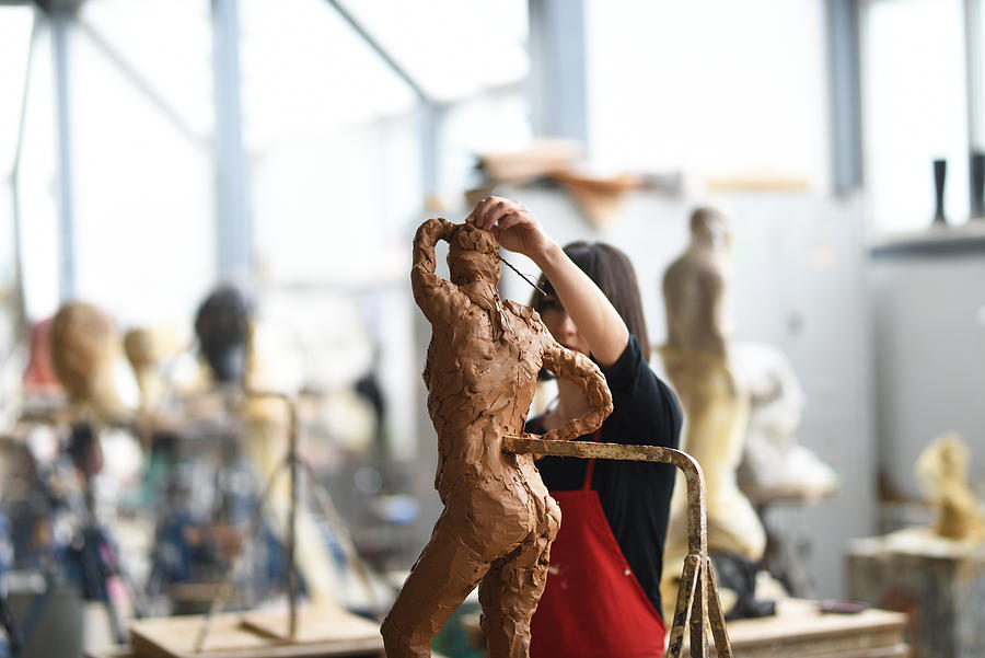 Young Female Sculptor is working in her studio #1 Photograph by Baranozdemir