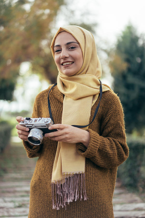 Young muslim woman photographer #1 Photograph by Hsyncoban