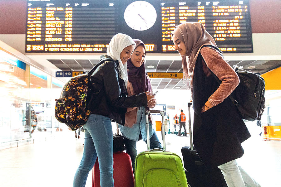 Young muslim women at train station leaving for a journey #1 Photograph by LeoPatrizi