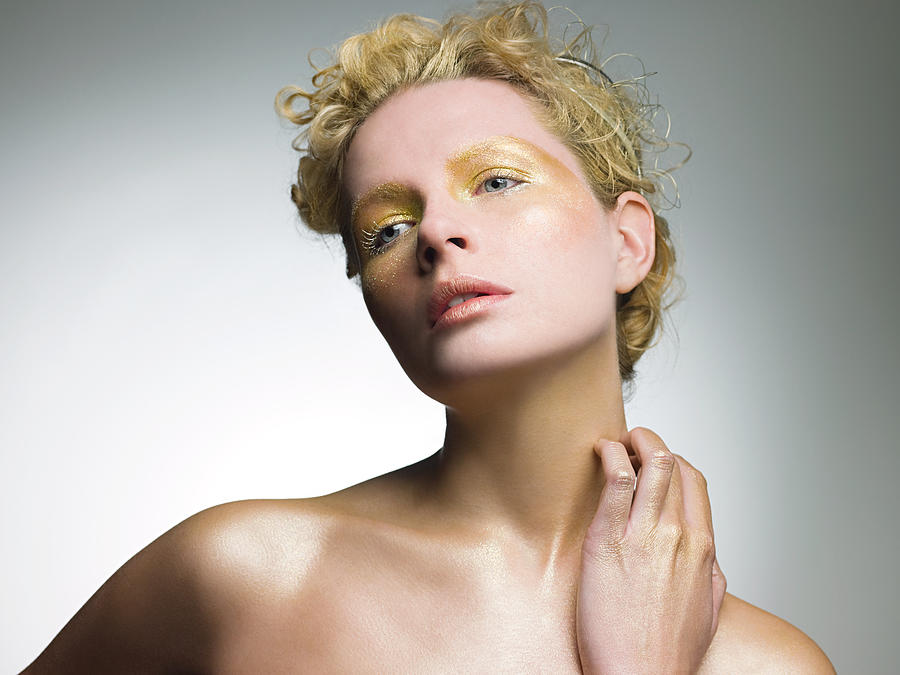 Young woman covered in gold make up #1 Photograph by Image Source